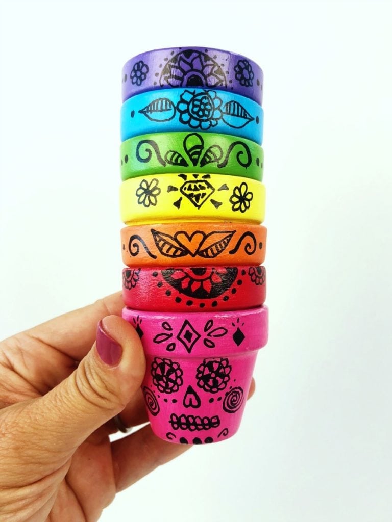 stack of colorful painted Sugar Skull Flower Pots 