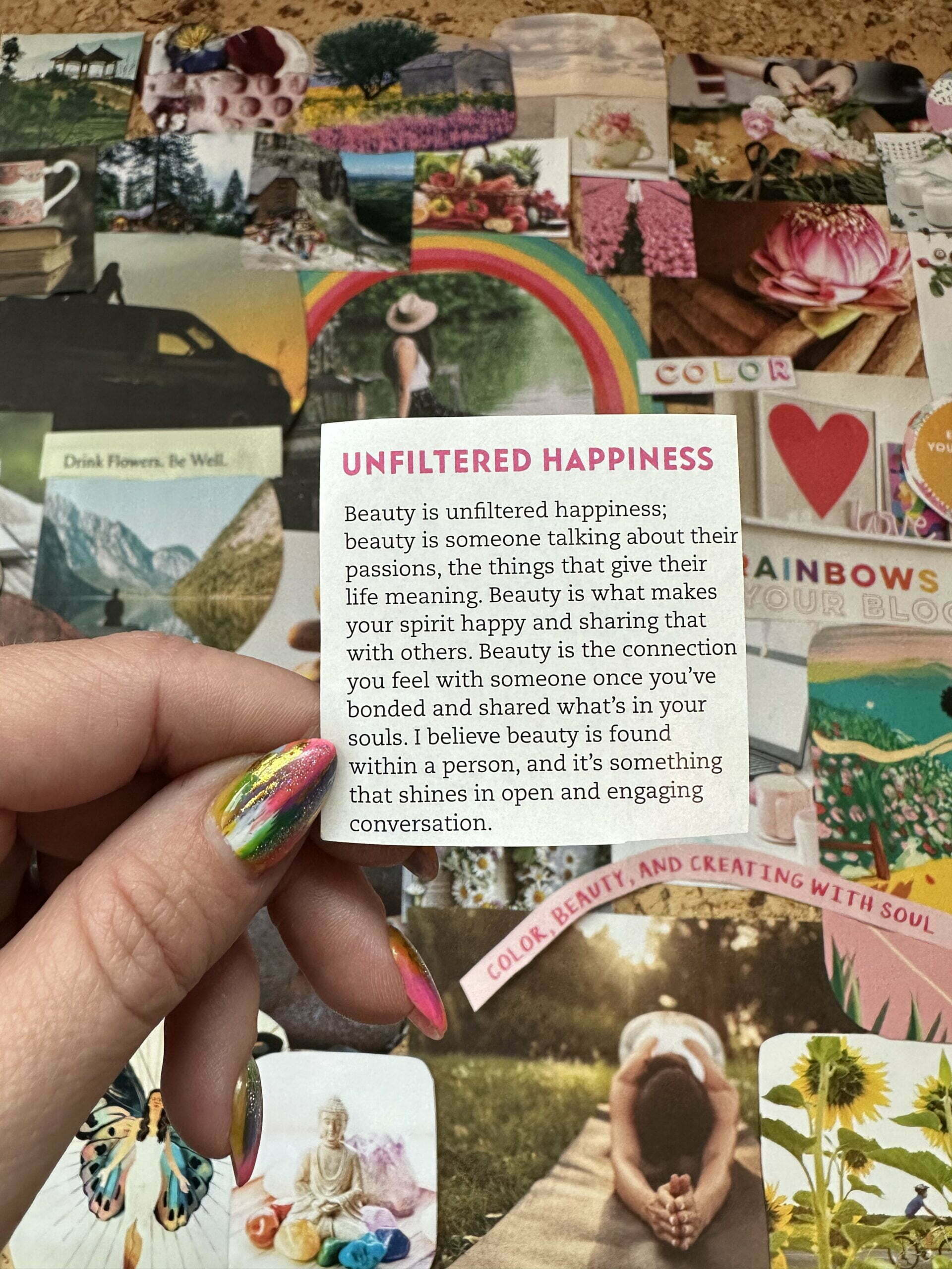 Holding up a quote about happiness above a completely vision board